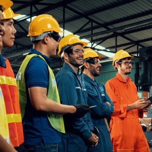 Skillful worker attending brief meeting in the factory . Industrial people and manufacturing labor concept .